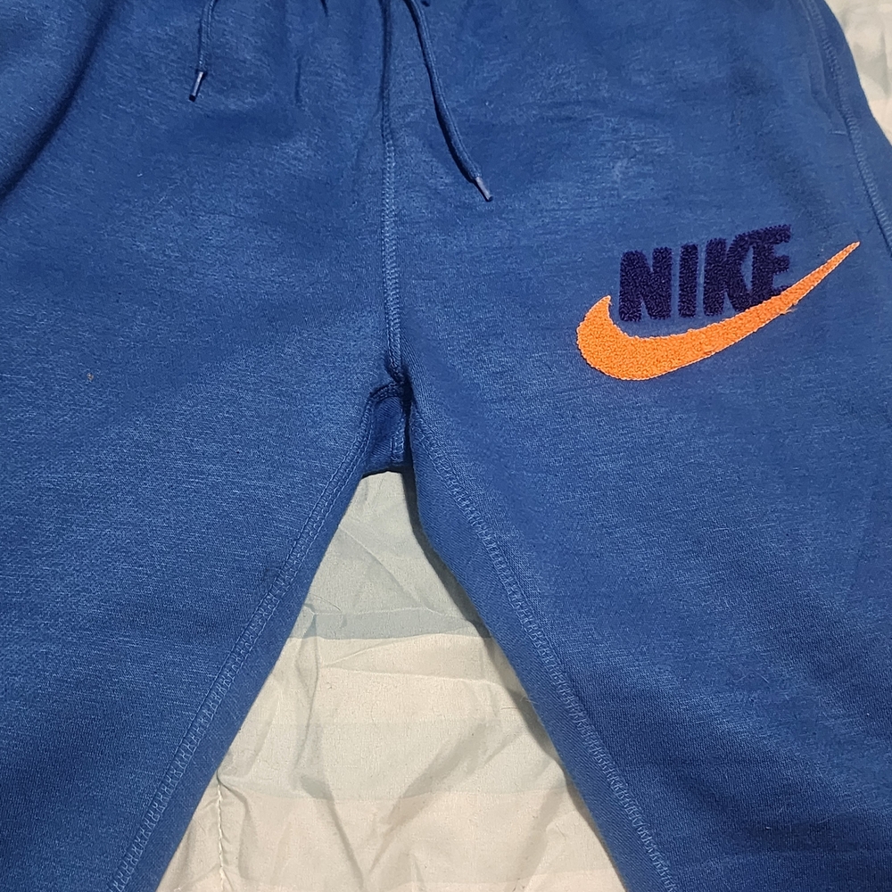 Nike Kids Joggers in Blue with Orange Logo